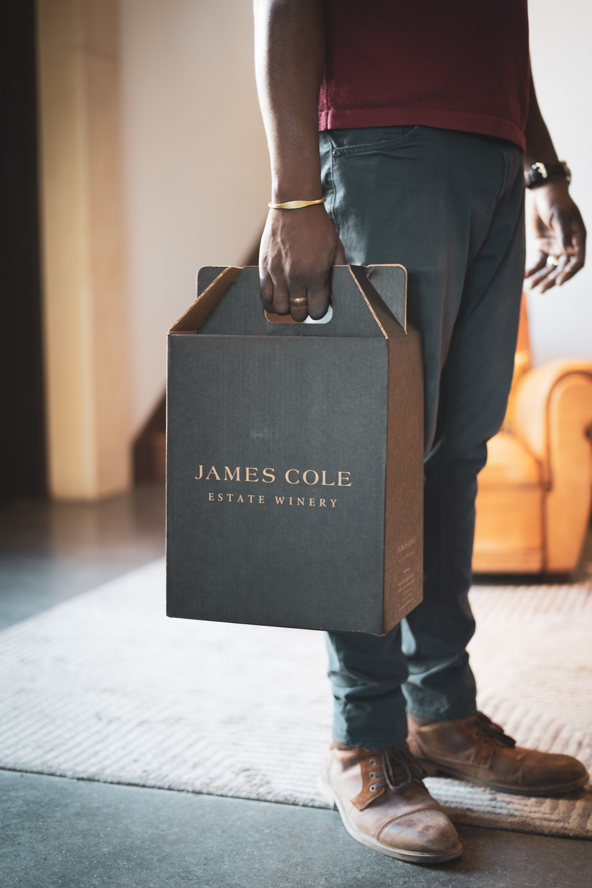 A person holding a James Cole wine box.