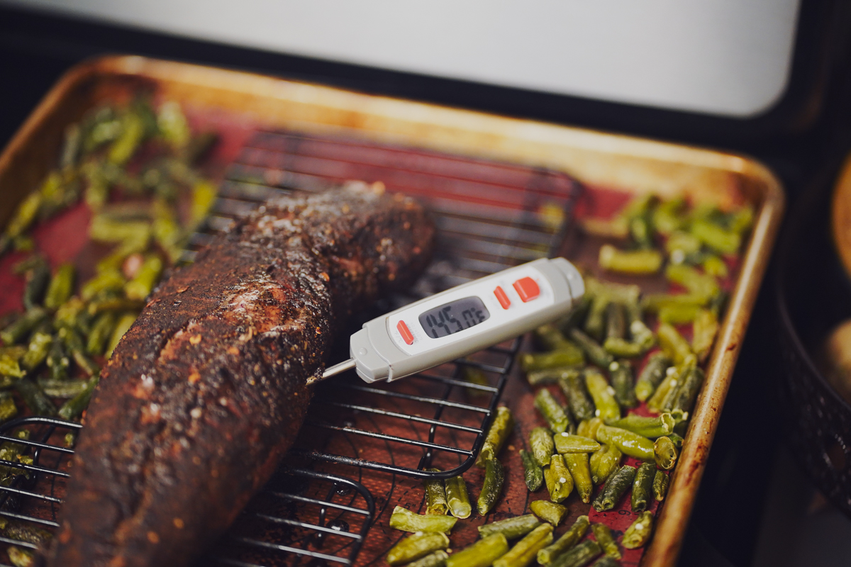 Pork tenderloin with a thermometer that reads 145 degrees F