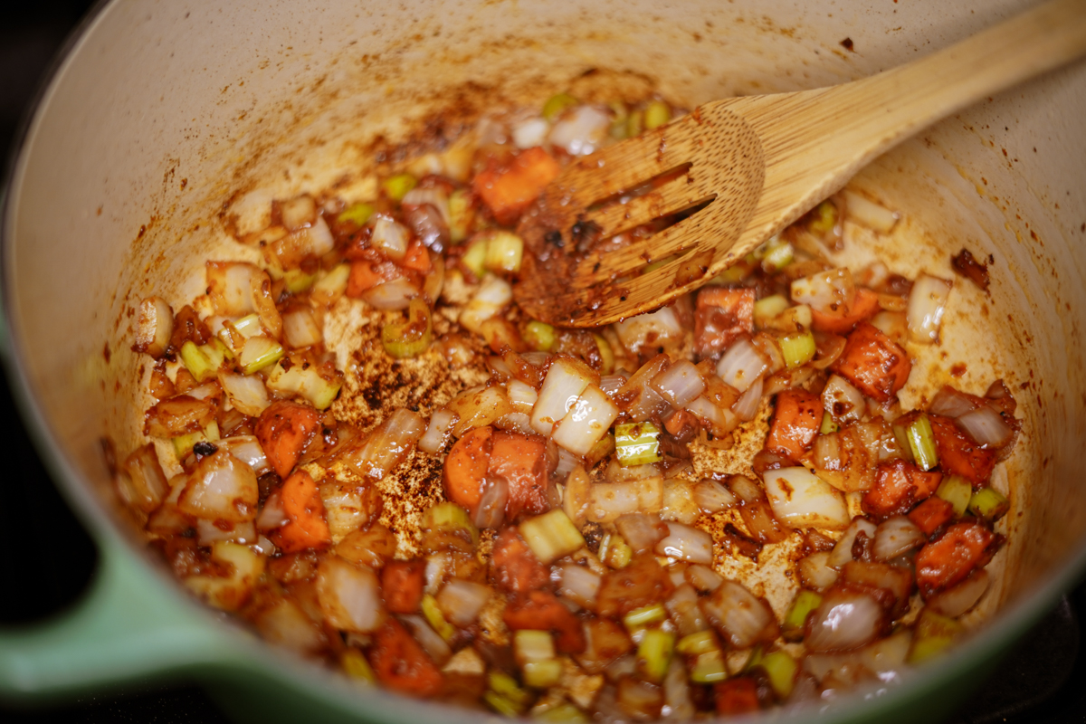 Mirepoix and Tomato paste sautéing in a dutch oven.