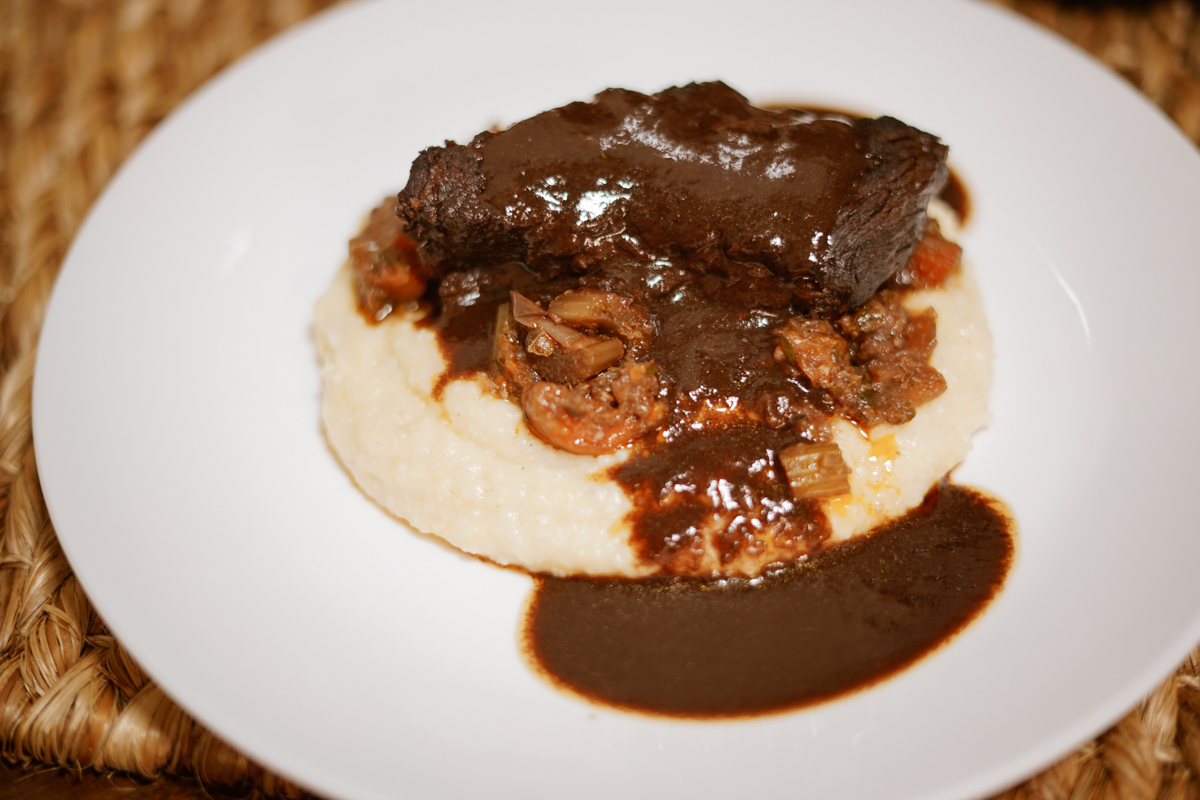 Beef short ribs served over polenta with a red wine reduction sauce.