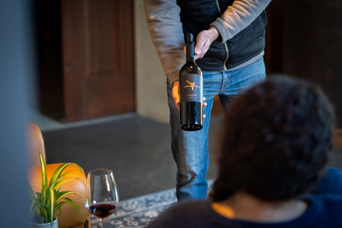 A host showcasing a wine during a tasting